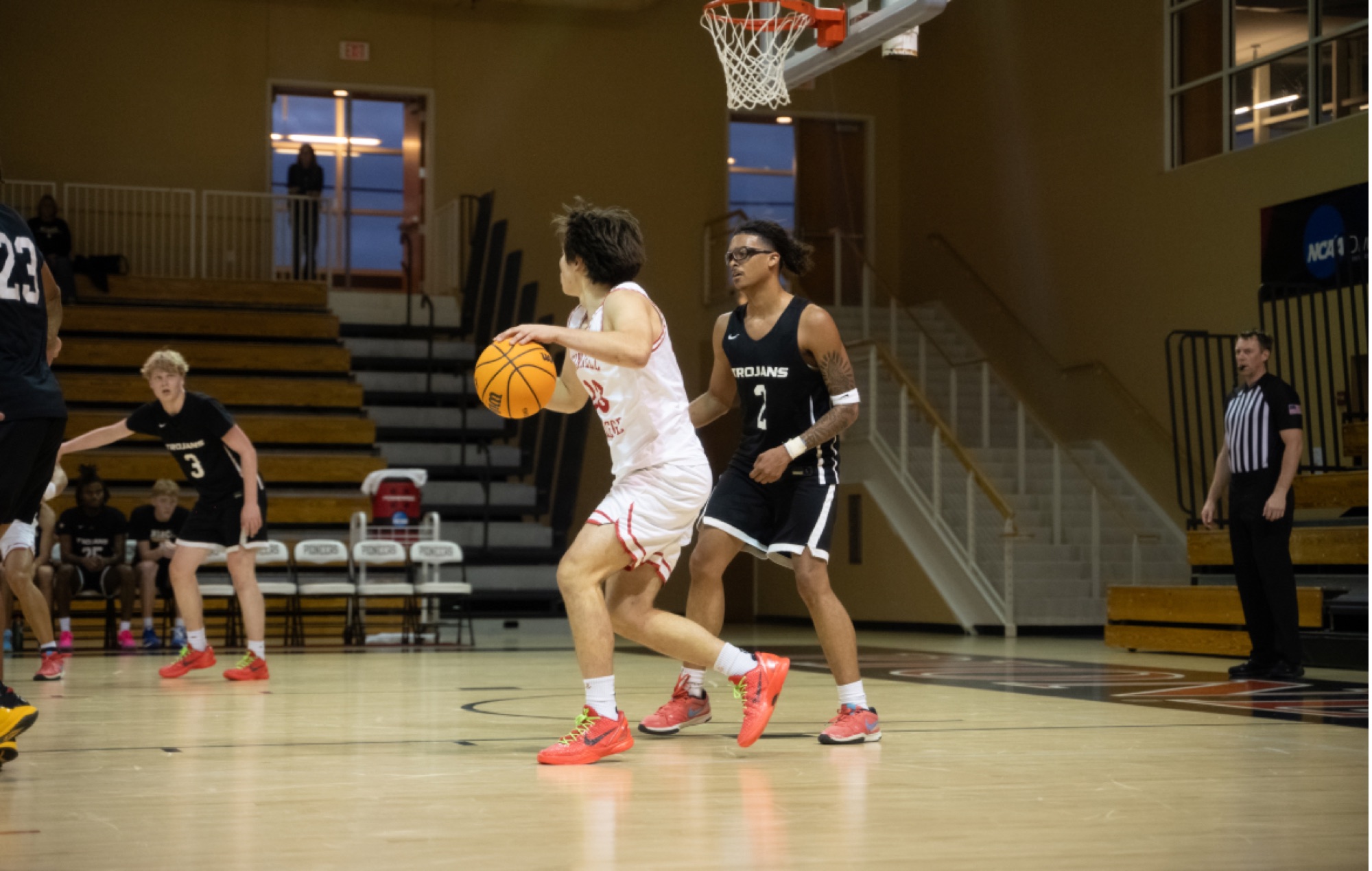 Jacques Godard drives past a defender for Grinnell College