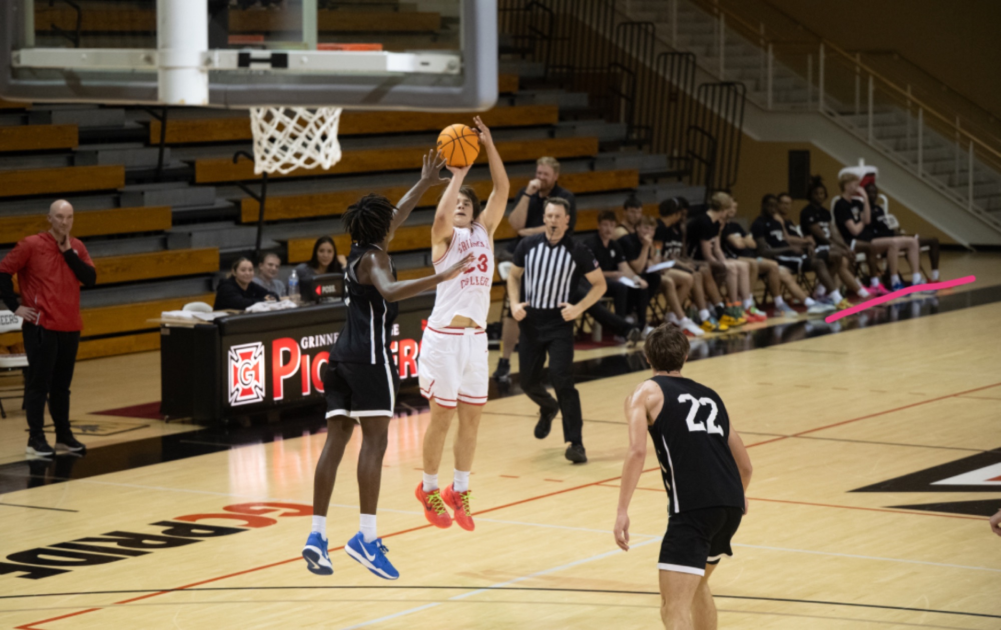 Jacques Godard rises for a jump shot in a Grinnell College game
